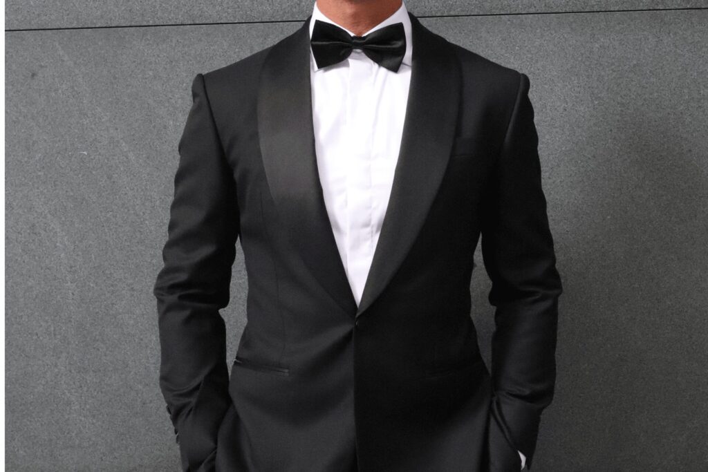 A black shawl-lapel dinner jacket with a white shirt and bow tie